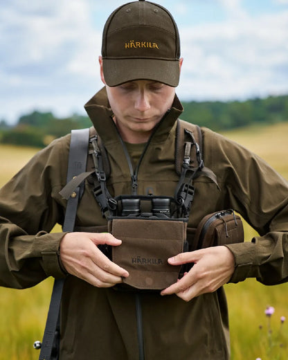 Dark Willow Green Coloured Harkila Utility Pouch on blurry background 