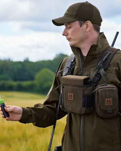 Dark Willow Green Coloured Harkila Utility Pouch on blurry background 
