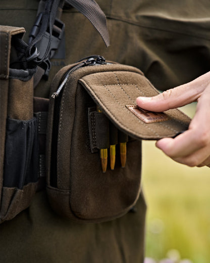 Dark Willow Green Coloured Harkila Utility Pouch on blurry background 