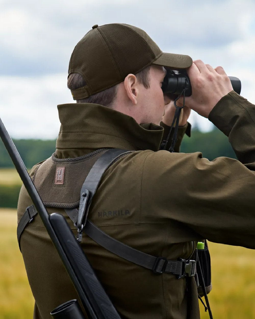 Dark Willow Green Coloured Harkila Utility Pouch on blurry background 