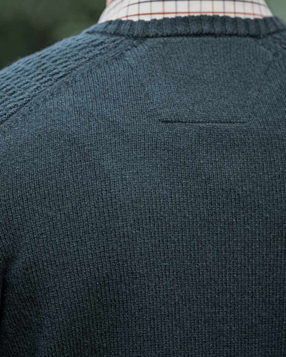 Dark Navy Coloured Harkila Vincent Merino V-Neck Pullover on forest background 