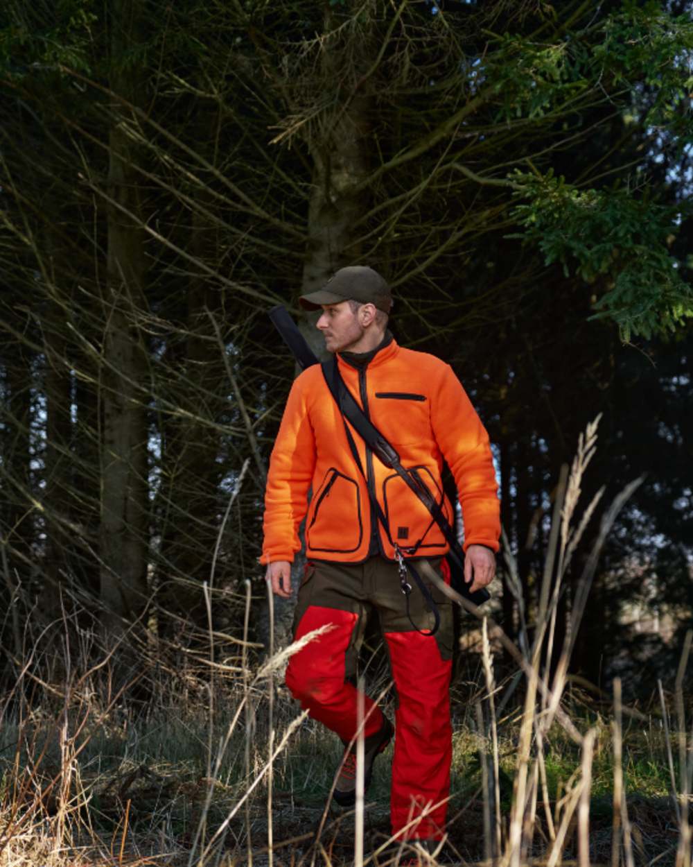 Orange Blaze Coloured Harkila Wildboar Pro Blaze Fleece Jacket on forest background 