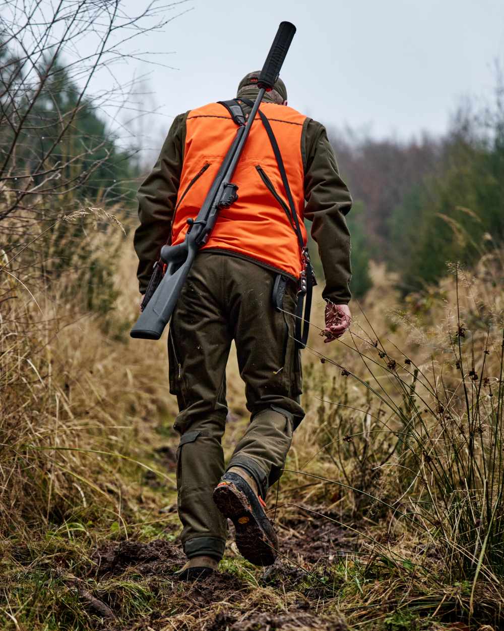Orange Blaze Brown Coloured Harkila Wildboar Pro Blaze Waistcoat on forest background 
