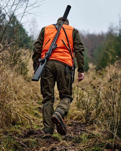 Orange Blaze Brown Coloured Harkila Wildboar Pro Blaze Waistcoat on forest background 