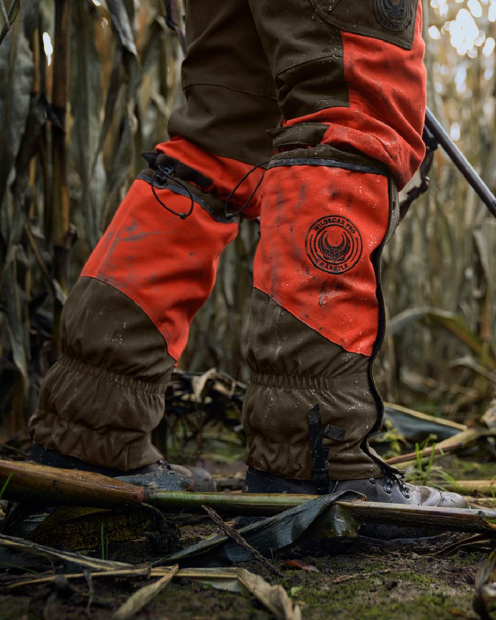 Orange Blaze Willow Green Coloured Harkila Wildboar Pro Gaiters on farm background 