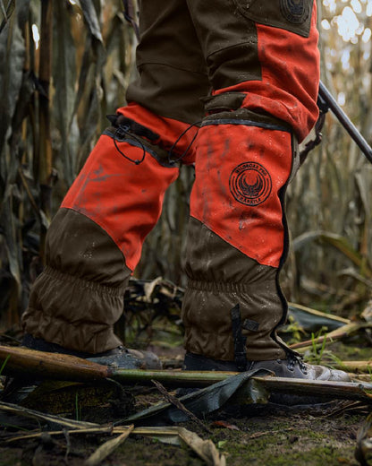 Orange Blaze Willow Green Coloured Harkila Wildboar Pro Gaiters on farm background 