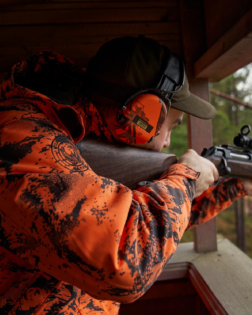 AXIS Orange Blaze Coloured Harkila Wildboar Pro HWS Insulated Jacket on outdoor background 