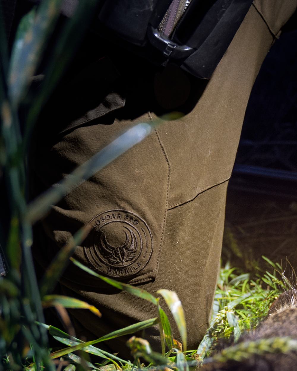 Willow Green Coloured Harkila Wildboar Pro Move Trousers on outdoor background 