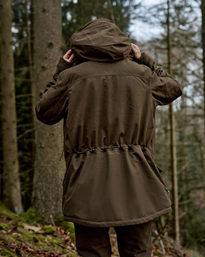 Willow Green Coloured Harkila Womens Driven Hunt HWS Insulated Jacket on forest background 
