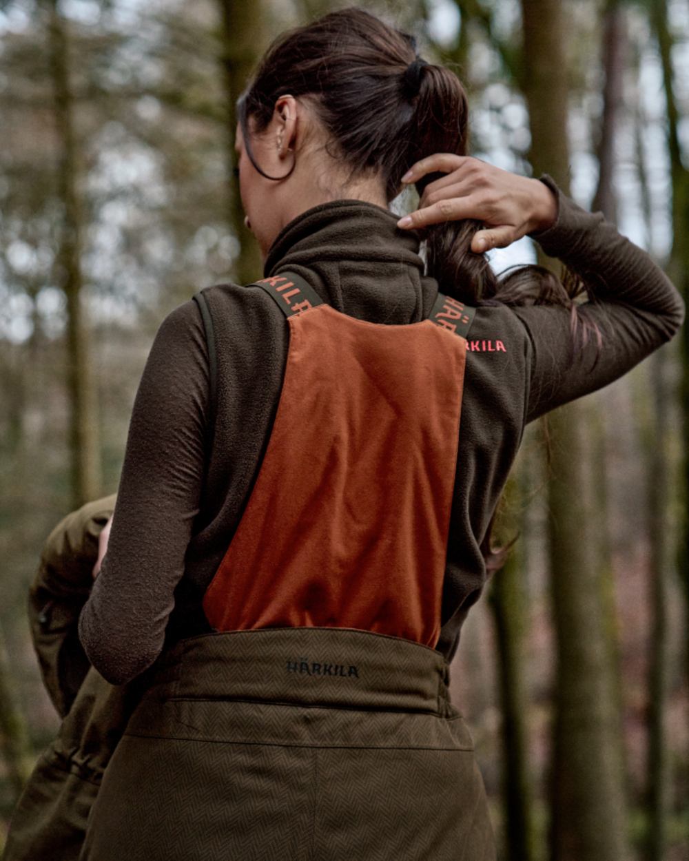 Willow Green Coloured Harkila Womens Driven Hunt HWS Insulated Trousers on forest background 