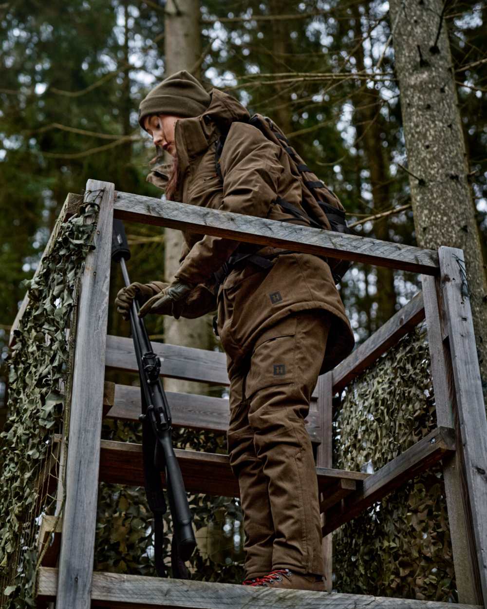 Willow Green Coloured Harkila Womens Driven Hunt HWS Insulated Trousers on forest background 
