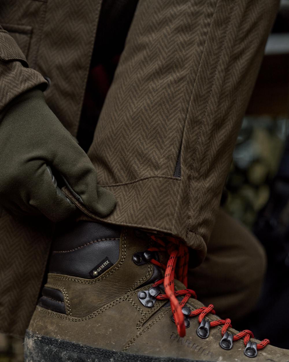 Willow Green Coloured Harkila Womens Driven Hunt HWS Insulated Trousers on forest background 