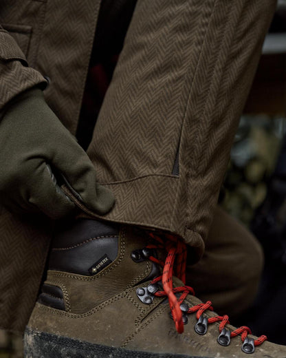 Willow Green Coloured Harkila Womens Driven Hunt HWS Insulated Trousers on forest background 