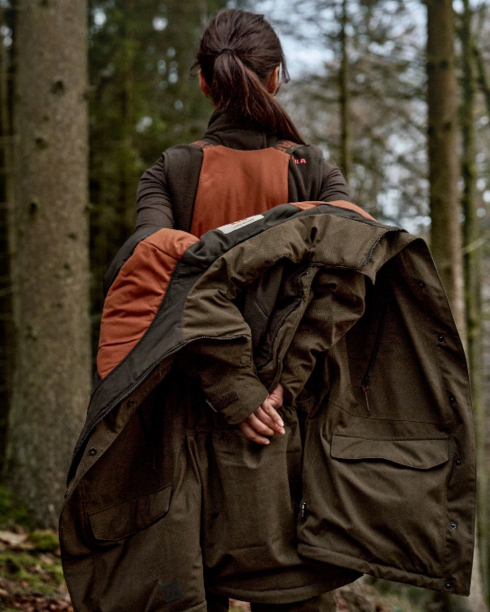 Willow Green Coloured Harkila Womens Driven Hunt HWS Insulated Trousers on forest background 
