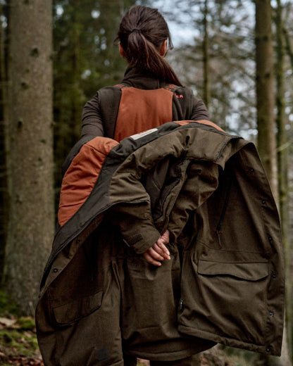 Willow Green Coloured Harkila Womens Driven Hunt HWS Insulated Trousers on forest background 