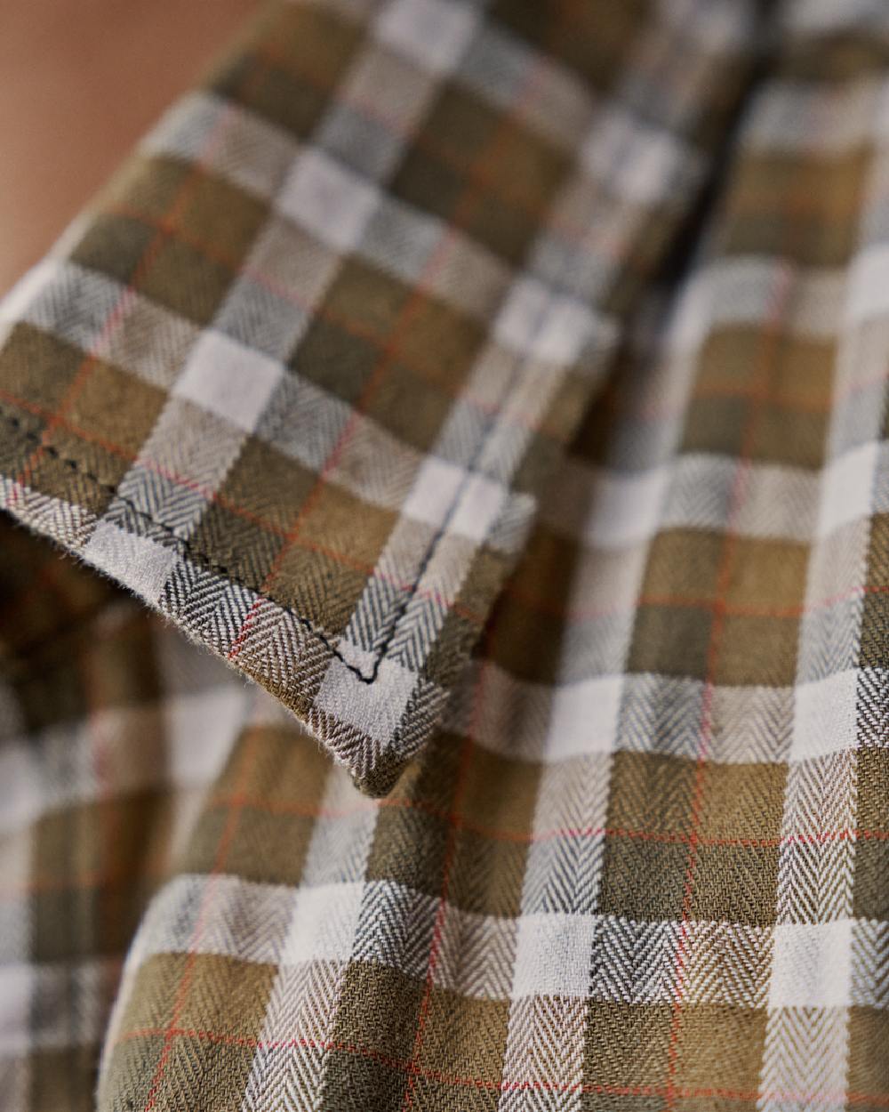 Dark Olive Check Coloured Harkila Womens Fjell Long Sleeve Shirt on blurry background 