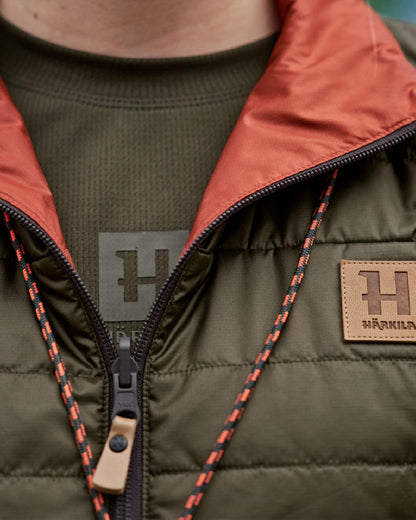 Willow Green Arabian Spice Coloured Harkila Womens Kalix HSP Waistcoat on blurry background 