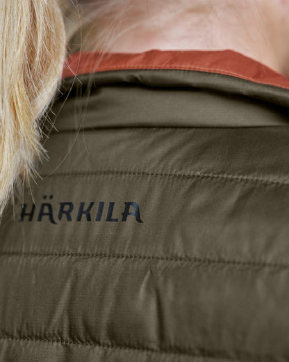 Willow Green Arabian Spice Coloured Harkila Womens Kalix HSP Waistcoat on blurry background 