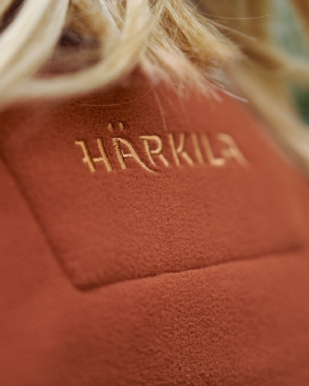 Dark Olive Arabian Spice Coloured Harkila Womens Kamko Reversible Windstopper Fleece Jacket on outdoor background 
