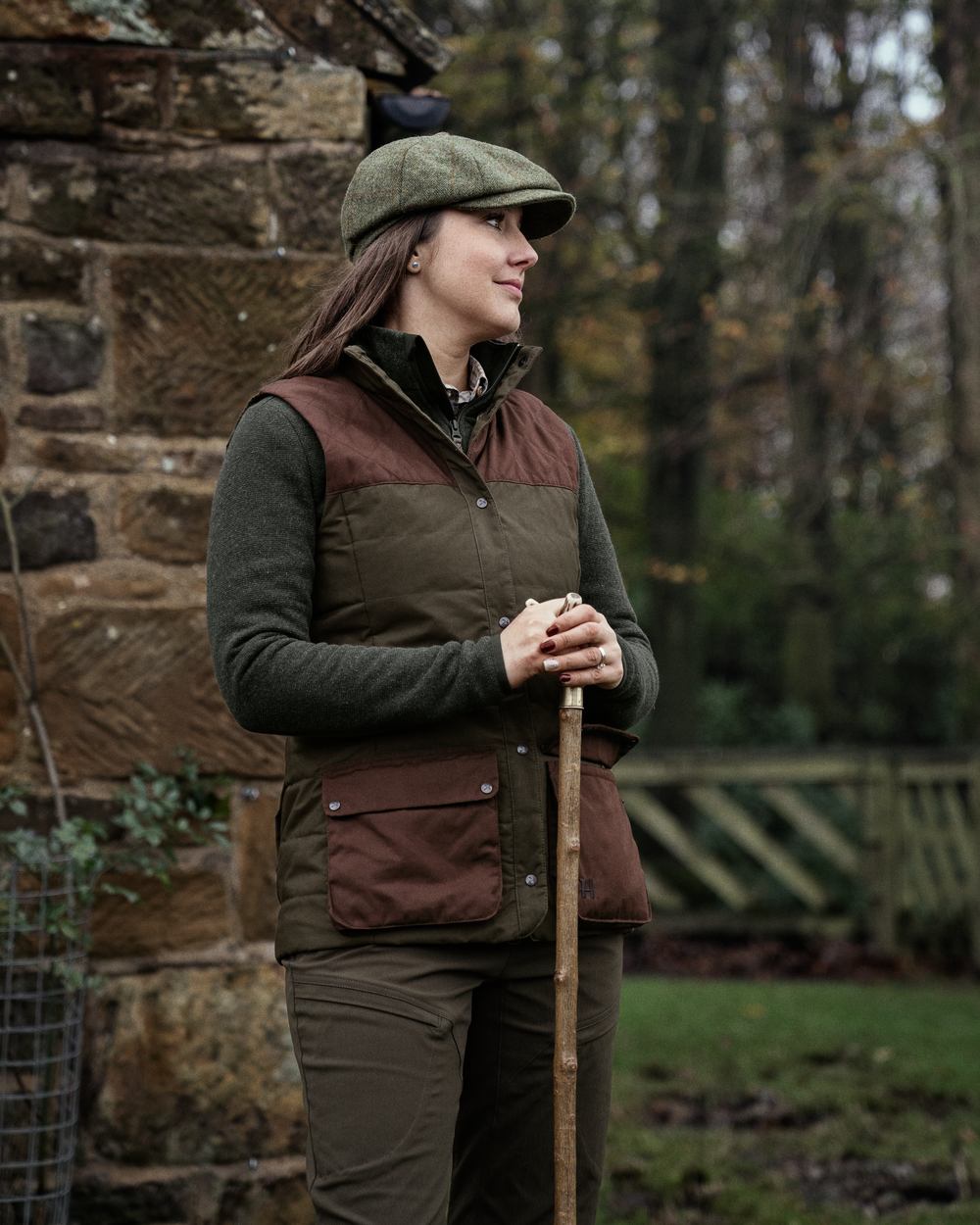 Dark Warm Olive Burgundy Coloured Harkila Womens Retrieve Waistcoat on outdoor background 