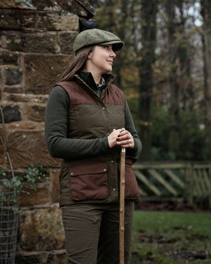 Dark Warm Olive Burgundy Coloured Harkila Womens Retrieve Waistcoat on outdoor background 