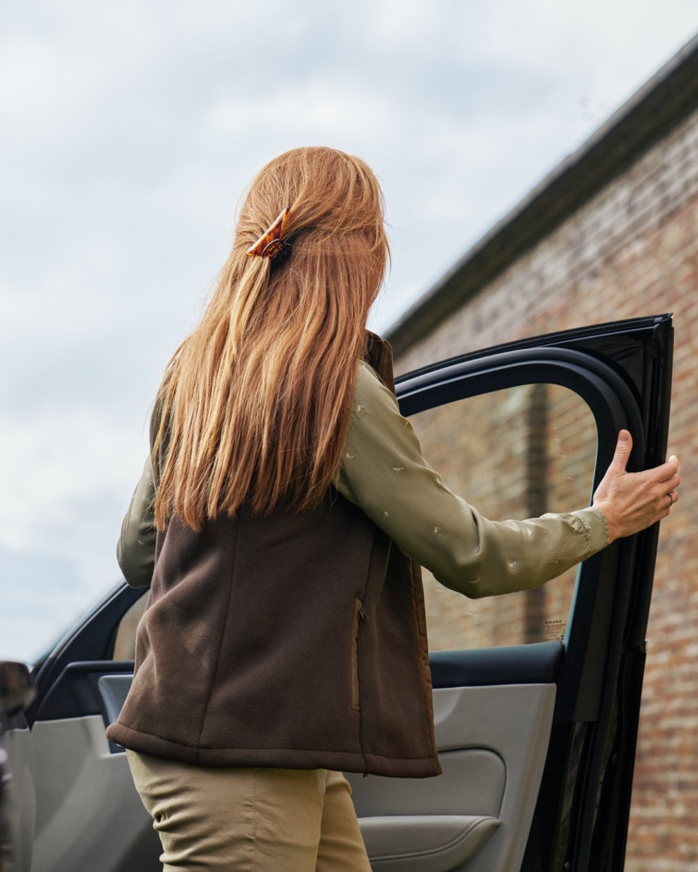 Demitasse Brown Coloured Harkila Womens Sandhem Sherpa Fleece Waistcoat on outdoor background 