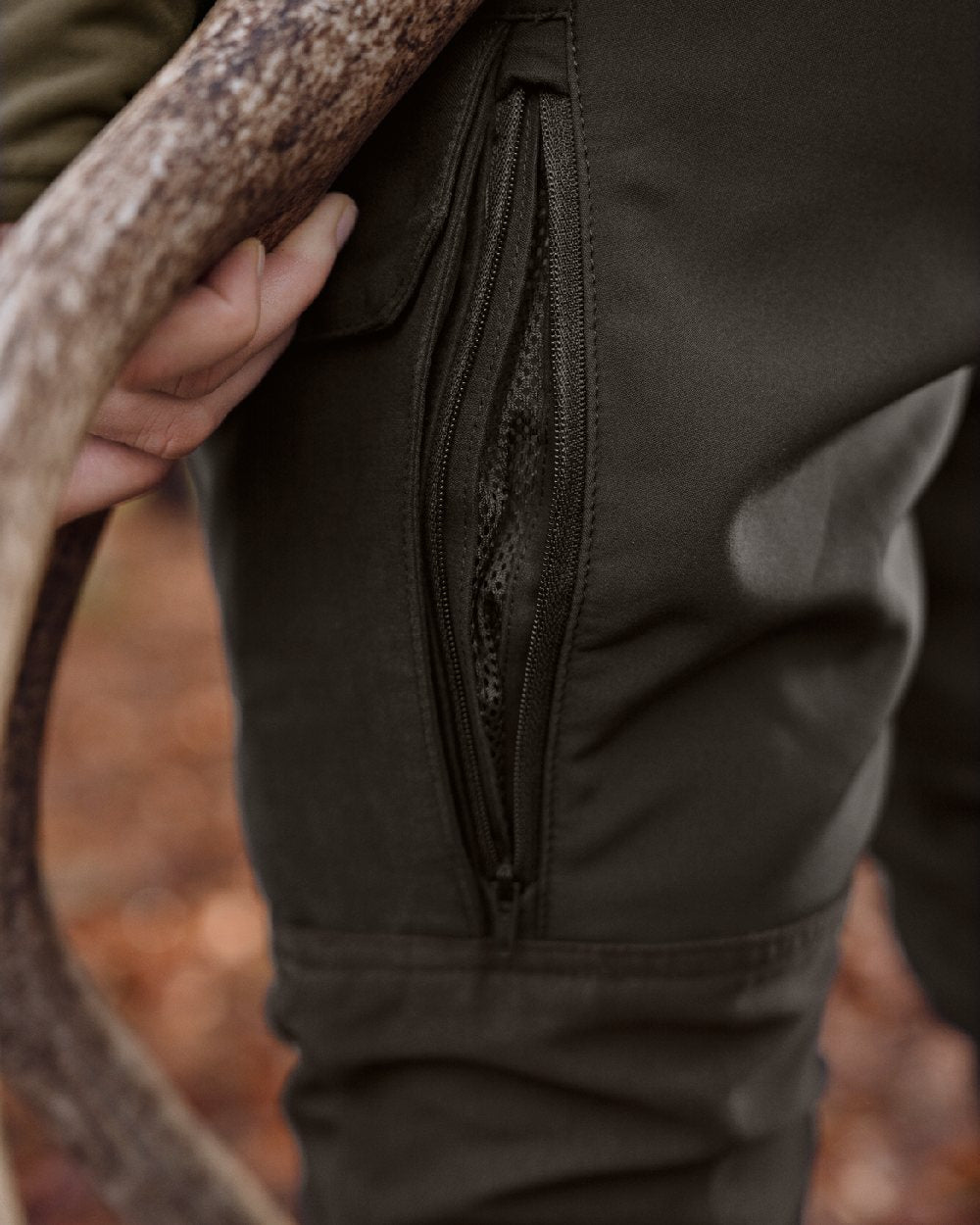 Shadow Brown Deep Brown coloured Harkila Womens Scandinavian Trousers on woodland background 