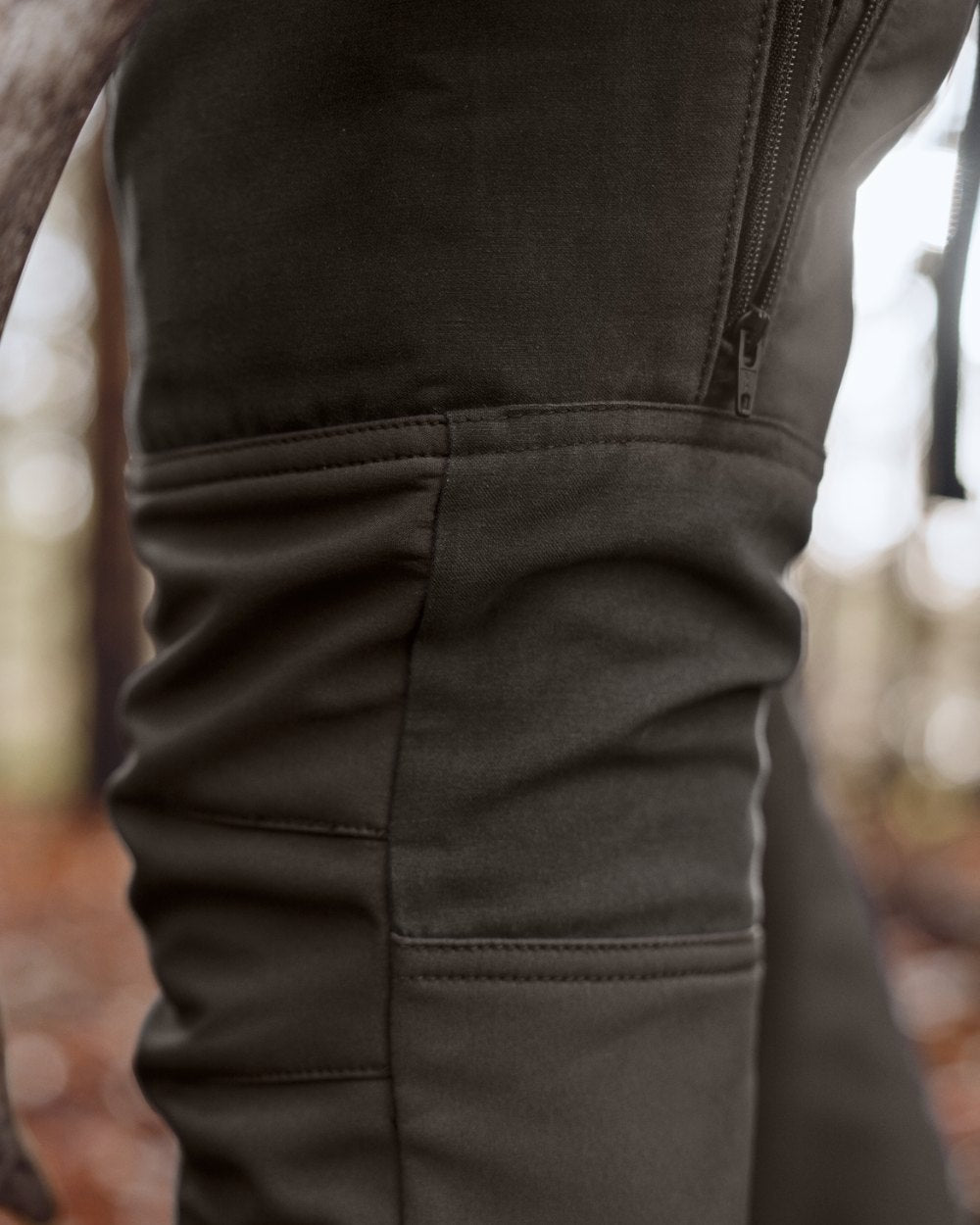 Shadow Brown Deep Brown coloured Harkila Womens Scandinavian Trousers on woodland background 