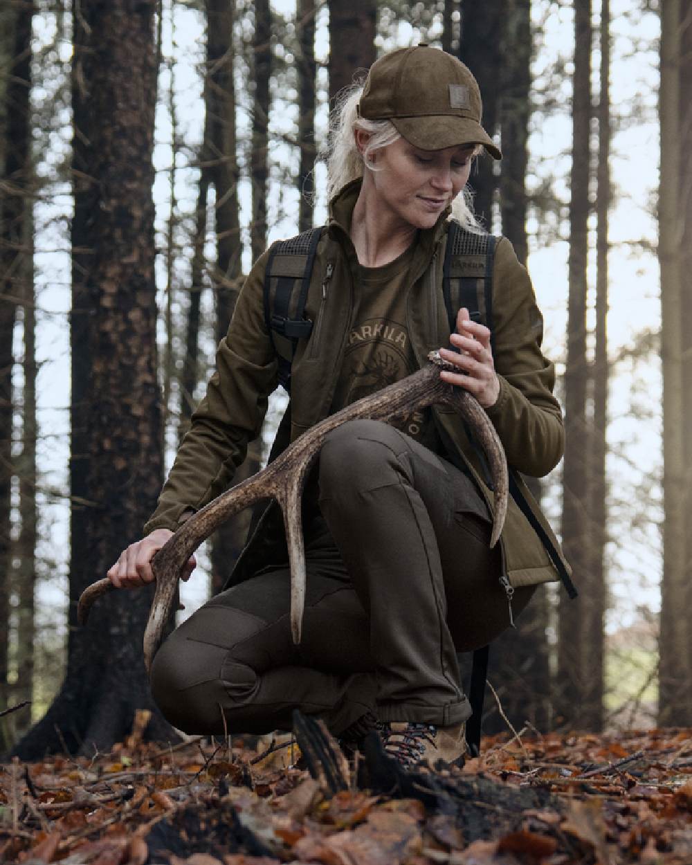 Shadow Brown Deep Brown coloured Harkila Womens Scandinavian Trousers on woodland background 