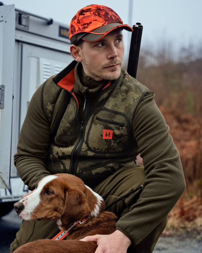 AXIS Limited Edition Orange coloured Harkila Kamko Pro Edition Reversible Hi-Vis Waistcoat on woodland background