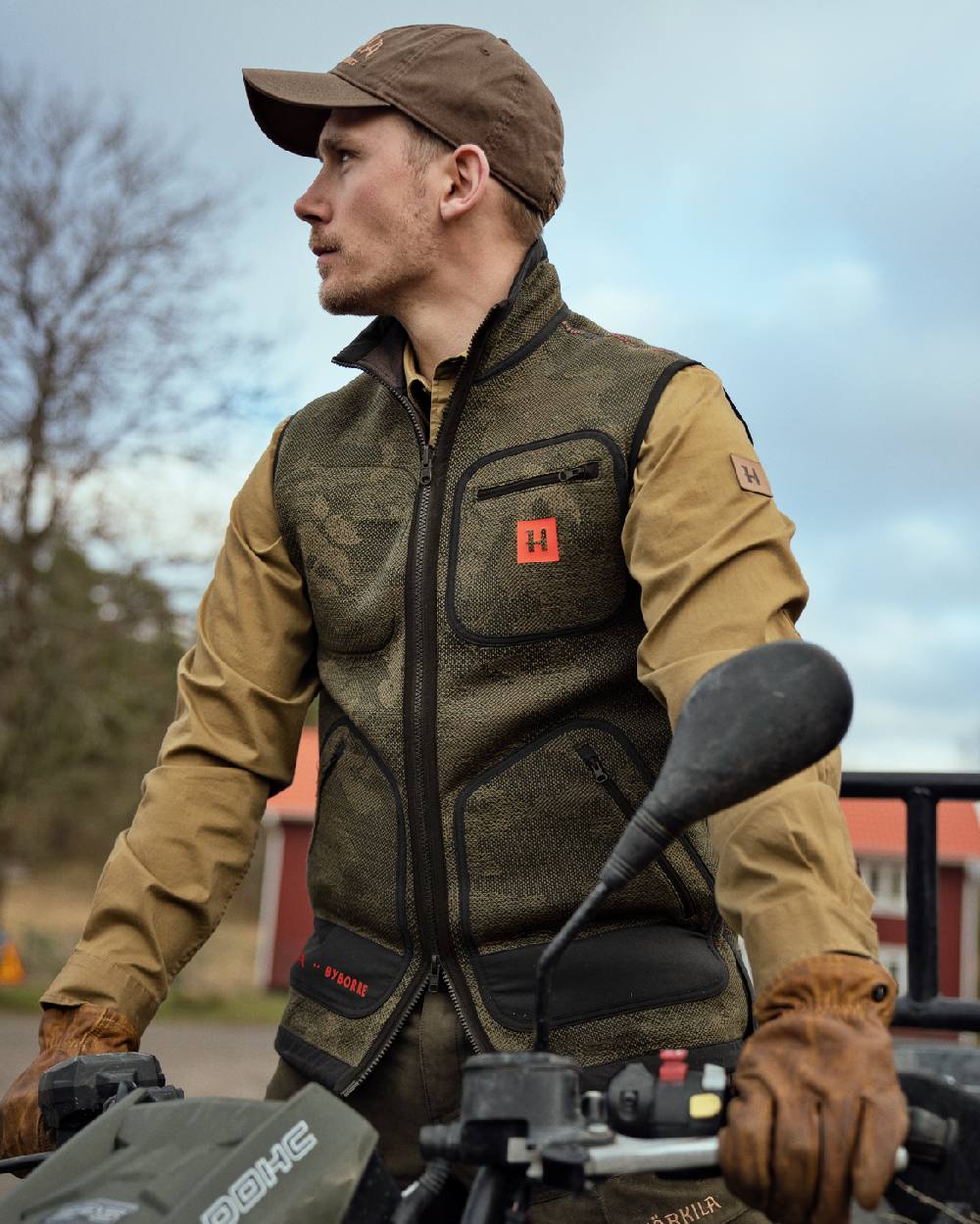 AXIS MSP Limited Edition coloured Harkila Kamko Pro Edition Reversible Waistcoat worn by man riding an ATV