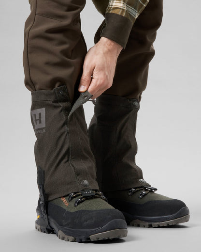 Shadow Brown coloured Harkila Ledge Gaiters on grey background