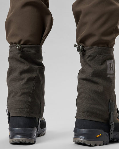 Shadow Brown coloured Harkila Ledge Gaiters on grey background