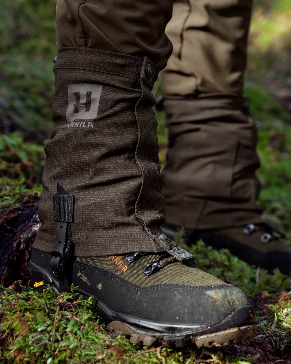 Shadow Brown coloured Harkila Ledge Gaiters on woodland background