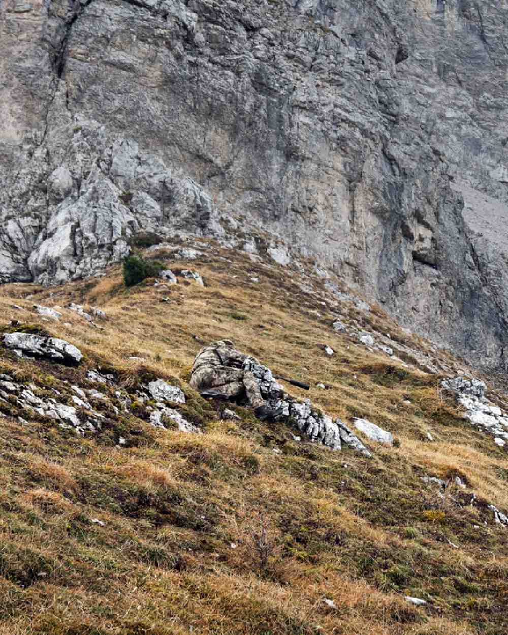 Hunter in the mountains wearing AXIS Mountain coloured Harkila Mountain Hunter Expedition HWS Packable Jacket