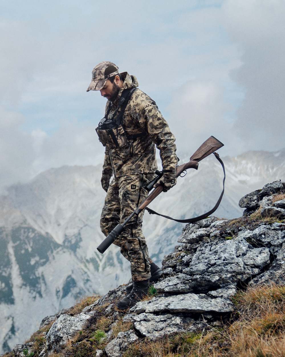 Hunter in the mountains wearing AXIS Mountain coloured Harkila Mountain Hunter Expedition HWS Packable Jacket