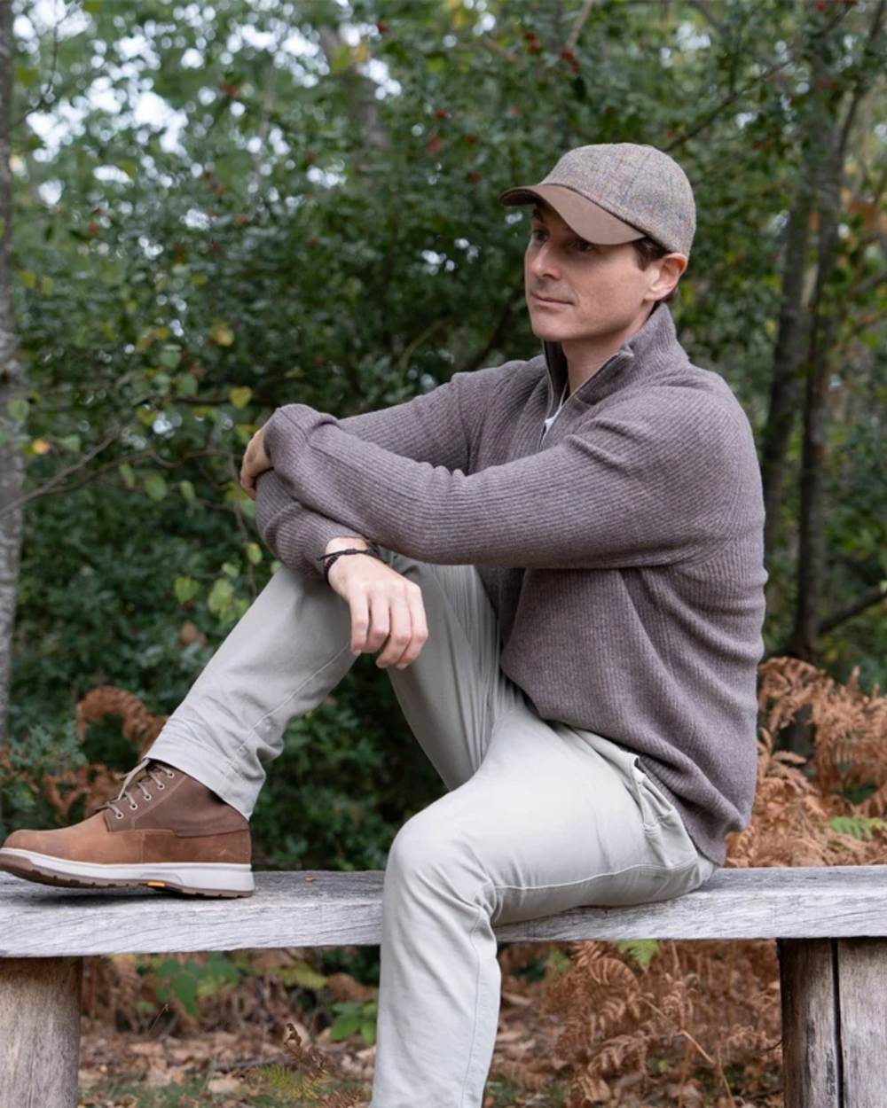 Mushroom Coloured Heather Glencairn Harris Tweed Leather Peak Baseball Cap on park background 