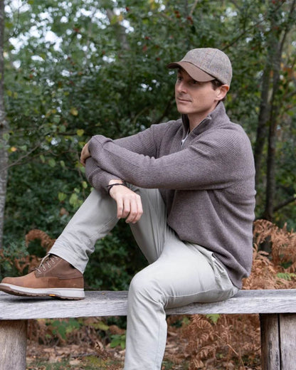 Mushroom Coloured Heather Glencairn Harris Tweed Leather Peak Baseball Cap on park background 