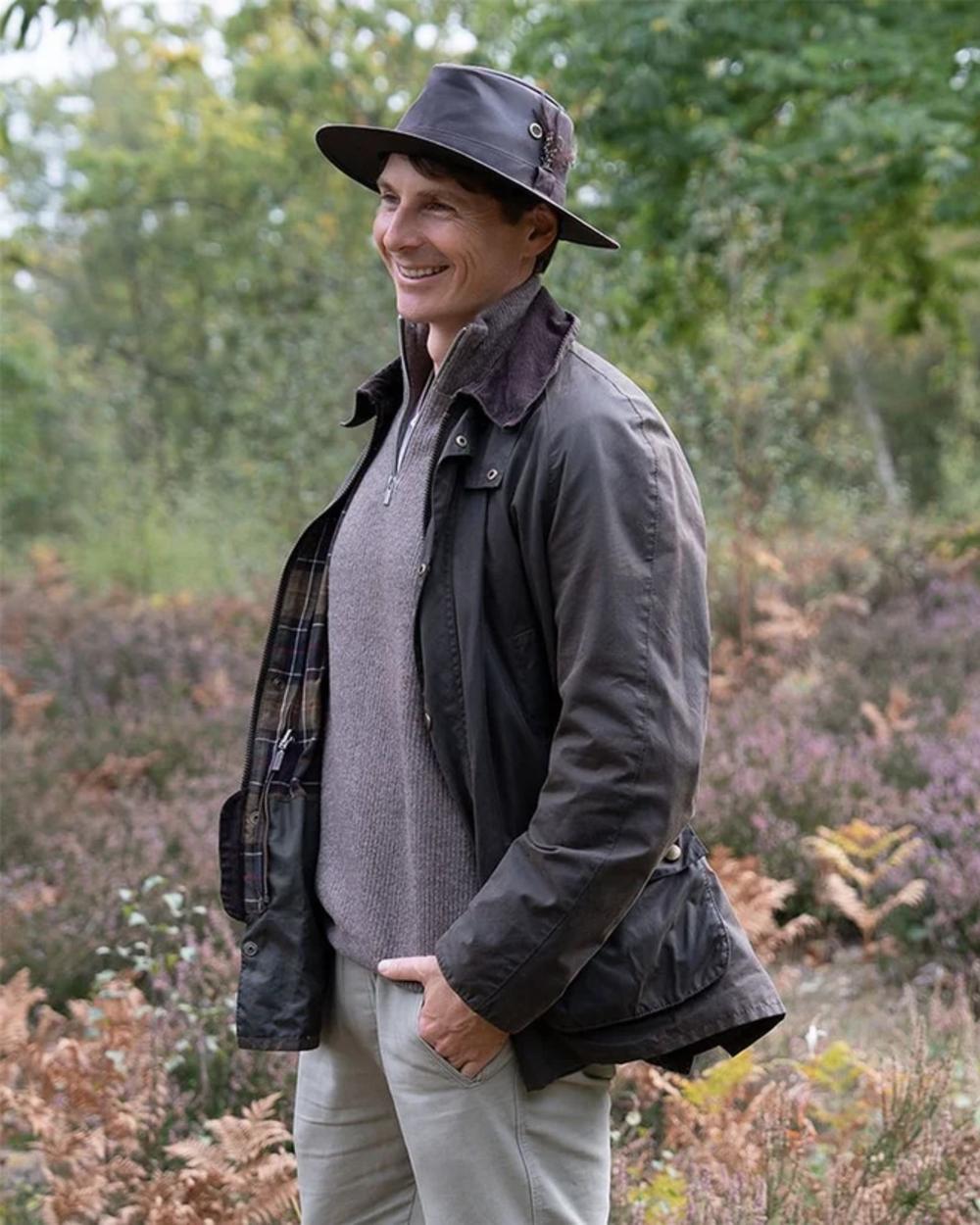 Deep Ocean Coloured Heather Rambler Wax Trilby Hat on woodland background 
