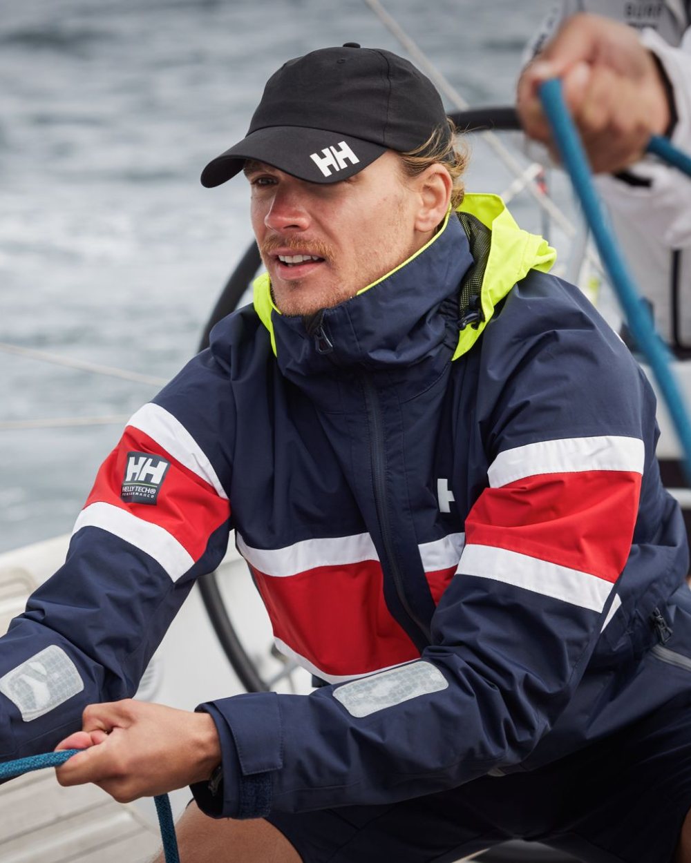 Ebony coloured Helly Hansen Crew Cap 2.0 on sea background 