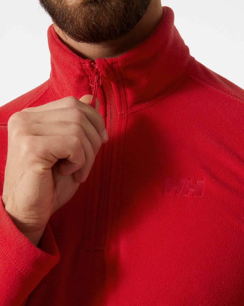 Red coloured Helly Hansen Daybreaker 1/2 Zip Fleece on white background 