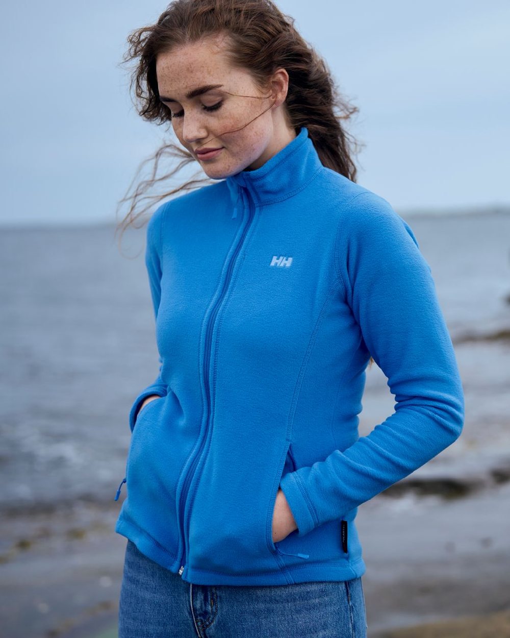 Ultra Blue coloured Helly Hansen Daybreaker Ladies Fleece Jacket on sky background 