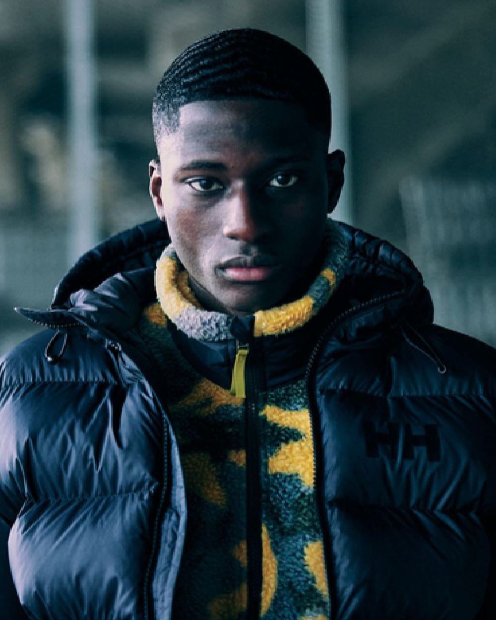 Black Coloured Helly Hansen Mens Active Puffy Jacket on outdoor background 