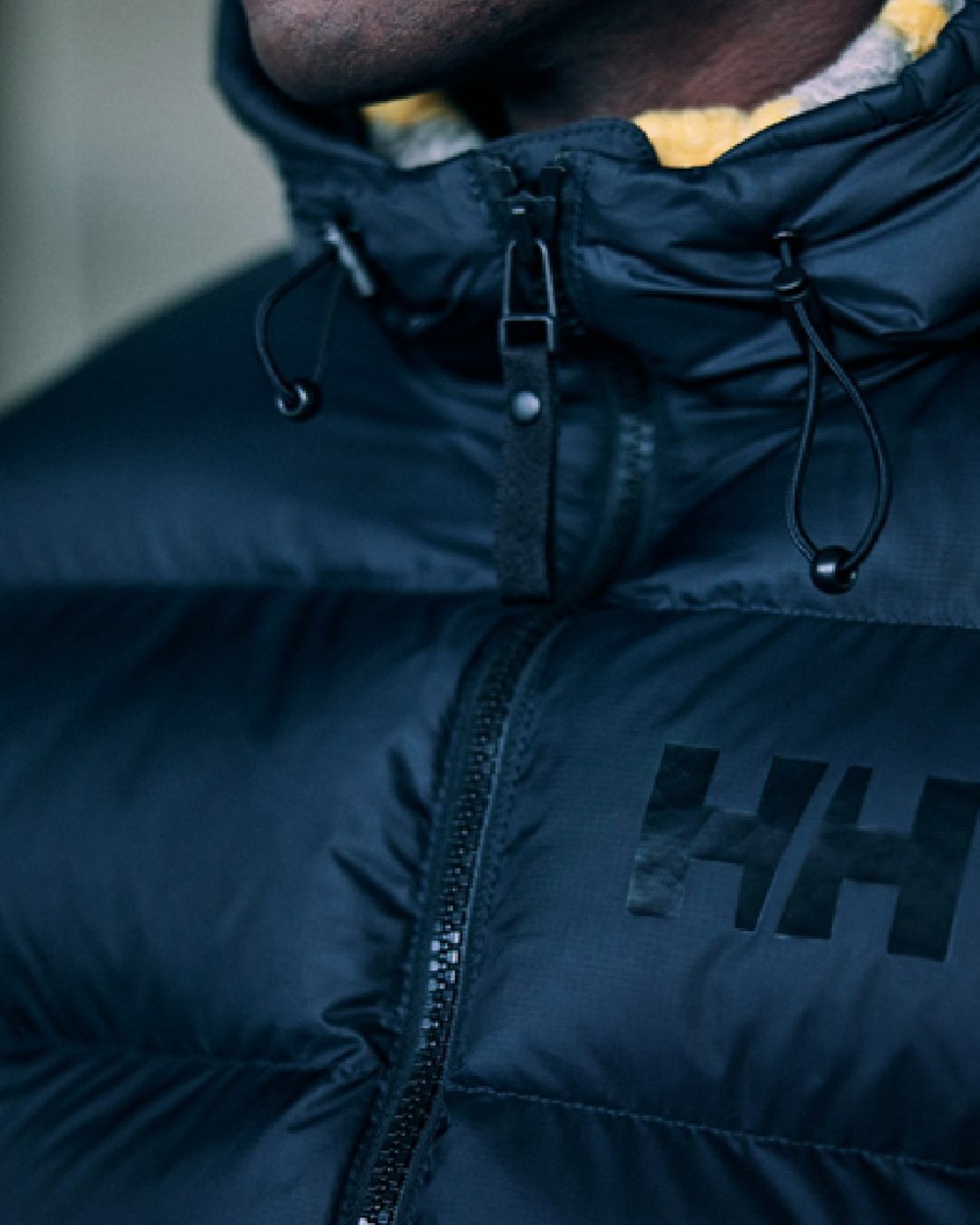 Black Coloured Helly Hansen Mens Active Puffy Jacket on outdoor background 