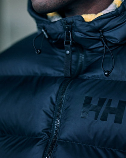 Black Coloured Helly Hansen Mens Active Puffy Jacket on outdoor background 
