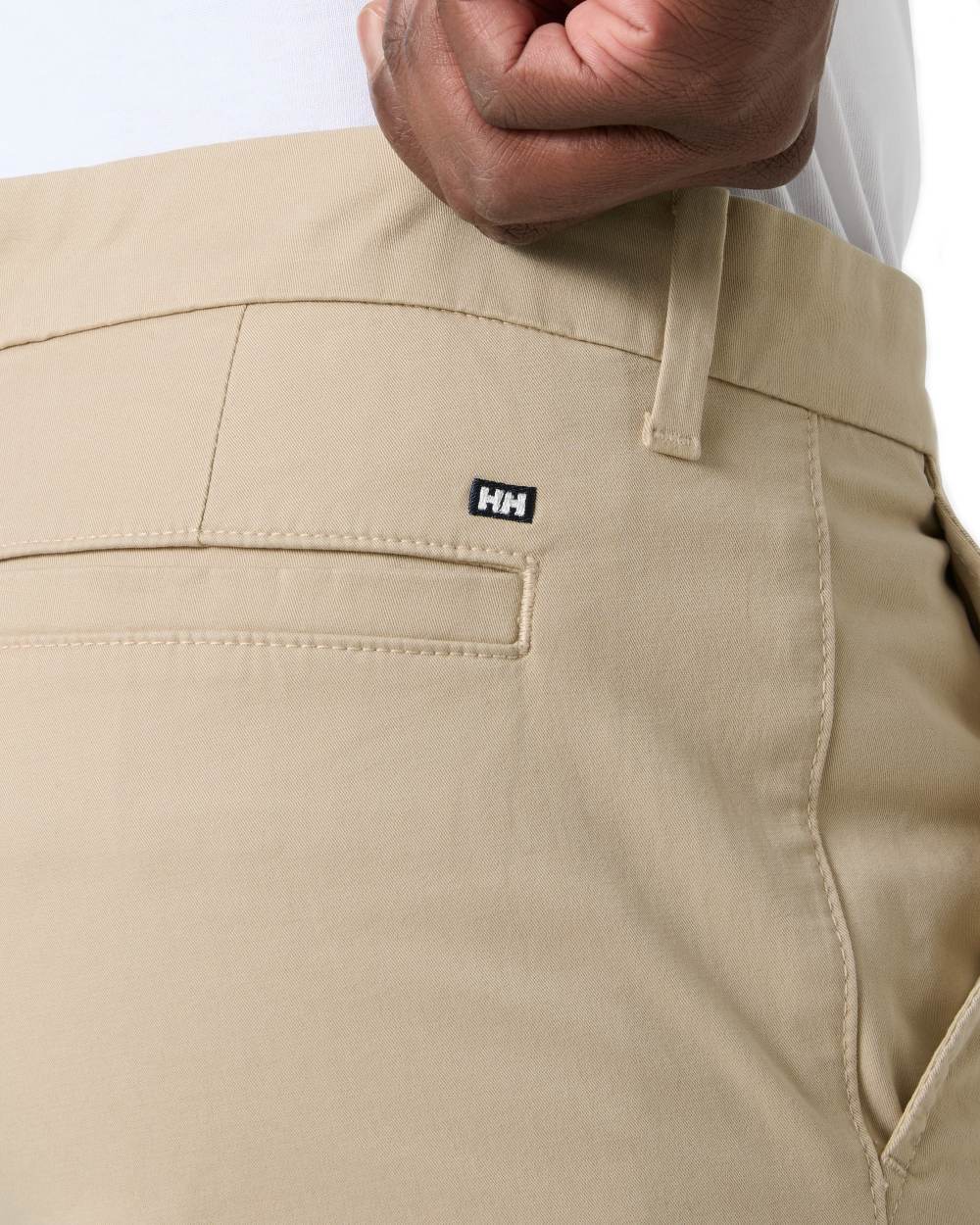 Khaki coloured Helly Hansen Mens Bryggen Chino Shorts on white background 