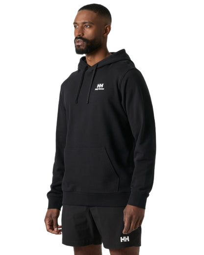 Black coloured Helly Hansen Mens Core Graphic Hoodie on white background 