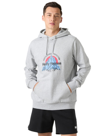 Grey Melange coloured Helly Hansen Mens Core Graphic Hoodie on white background 