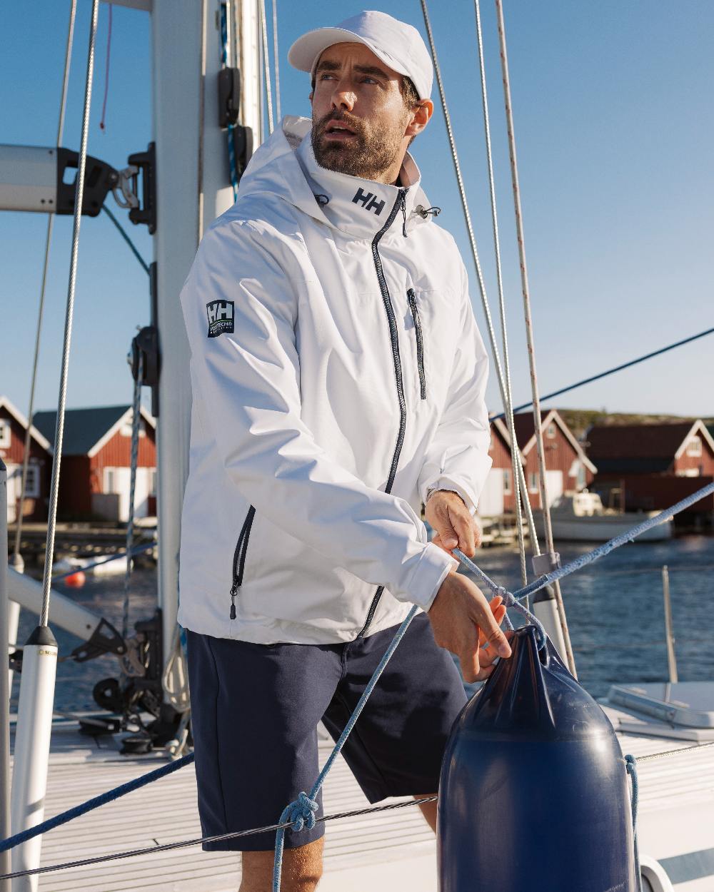 White Coloured Helly Hansen Mens Crew Hooded Jacket 2.0 on outdoor background 