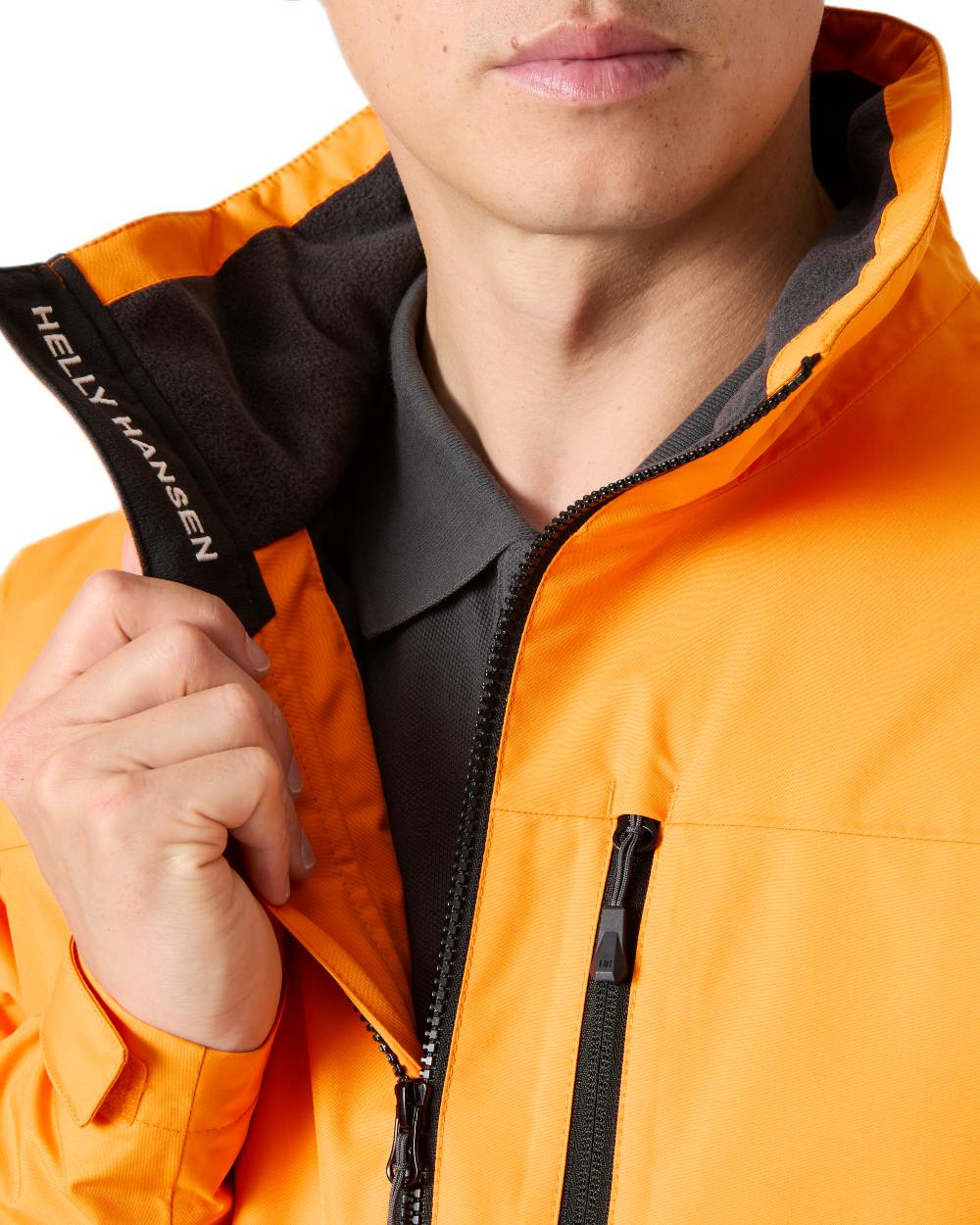 Ignite Orange coloured Helly Hansen Mens Crew Insulated Sailing Jacket 2.0 on white background 